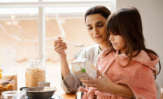 mom and girl looking at label