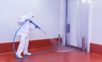 man sanitizing a room