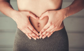 woman making a heart sign with her hands