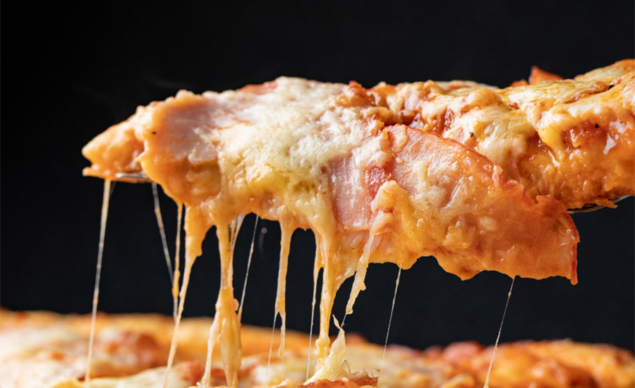 The stretch of cheese on a pizza contributes to its All-American taste.