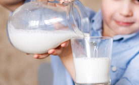 child pouring milk