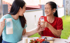 two women drinking milk together